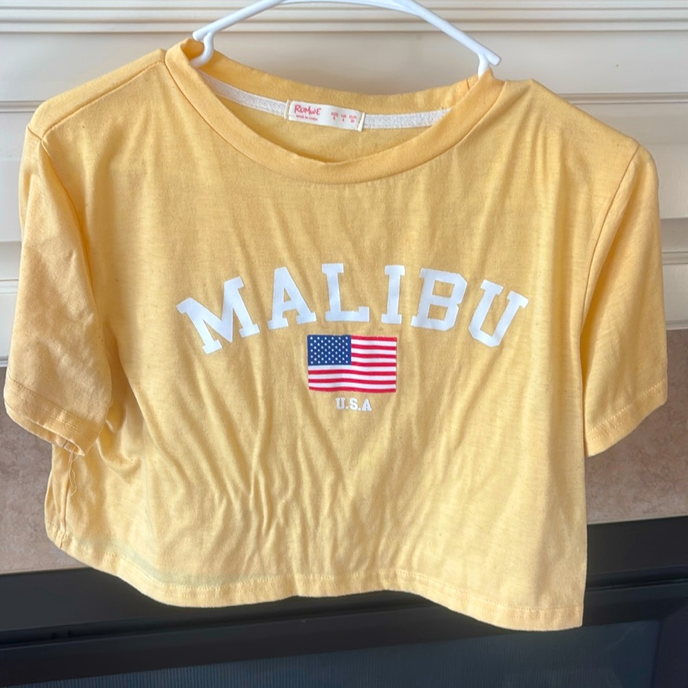 Light yellow Malibu cropped graphic tee.